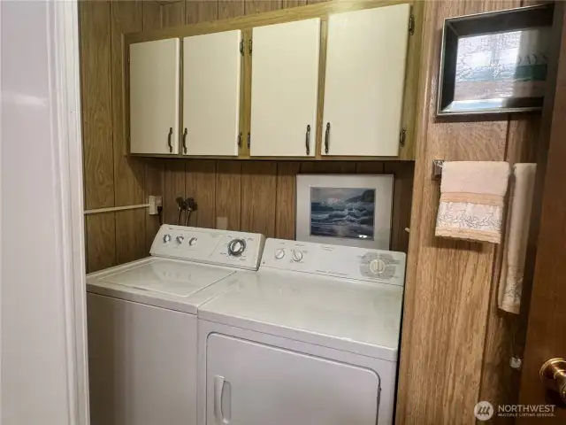 Laundry room has extra storage.