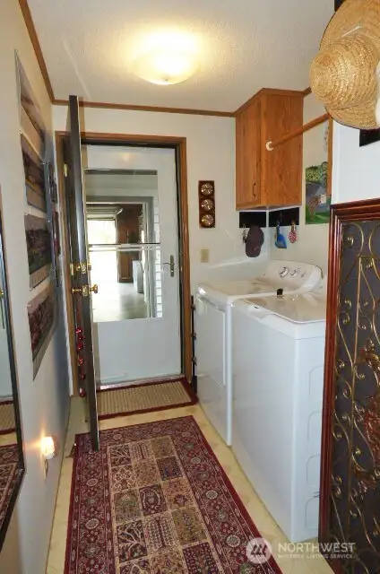 Laundry room with door to breezeway and garage. Washer and dryer stay too!