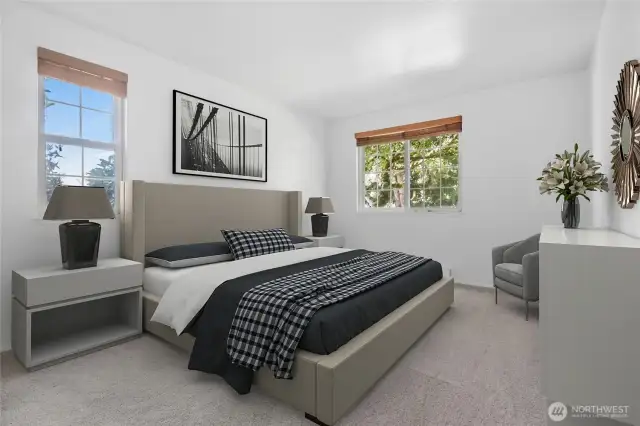 Spacious primary bedroom overlooking lovely landscaping.