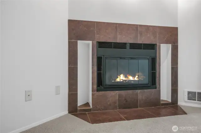 Woodburning fireplace with tile surround.