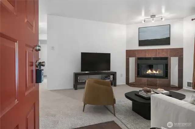 Enter to the living area with cozy fireplace.