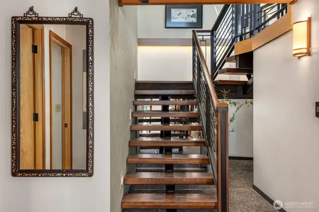 Beautiful custom stairs and rails grace the entry hall