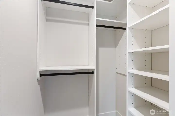 This clean, built-in closet offers smart organization with open shelving and dual hanging rods—perfect for keeping essentials tidy and accessible.