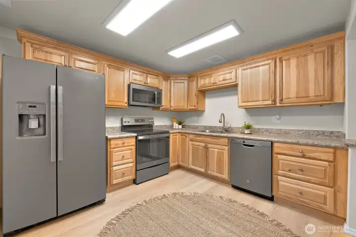 Lower level has two bedrooms, a full bath, living room, private entrance, and this big kitchen.