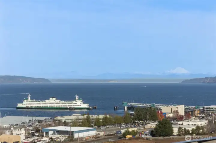 Experience elevated coastal living in this stunning one-level condo showcasing Puget Sound and mountain views. Thoughtfully designed with modern elegance, with tastefully done updates—wide-plank hardwoods, quartz counters, euro cabinetry, stainless appliances, and electronic blinds. The chef’s kitchen and eating bar and open layout creates effortless flow for entertaining. Retreat to the luxurious primary suite with a gorgeous bathroom and walk-in closet. Beautiful 2nd bedroom with a walk-in closet. Additional modern style full bath. Enjoy upscale amenities—rooftop terrace featuring panoramic views, BBQ, owners’ lounge, gym, and two parking spaces and storage unit. Minutes to charming downtown Edmonds, the waterfront, ferries and much more!