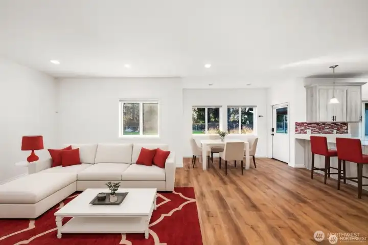 Open concept living room adjacent to the kitchen & eating nook. Overlooks the backyard which has trees behind it for added privacy and a beautiful view.
