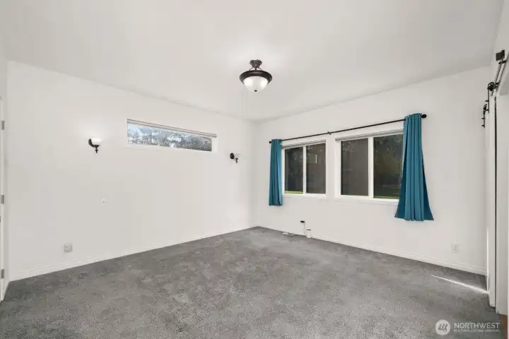 Primary bedroom is light and bright. Great views from the windows.