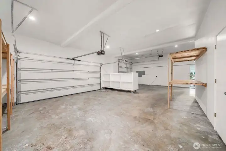 Overview of most of the 3 car garage. Complete with shelving and seperate entry into the upstairs where a MIL apt awaits.