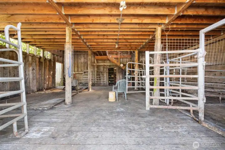 Interior of barn with new flooring and supports for the upper story.