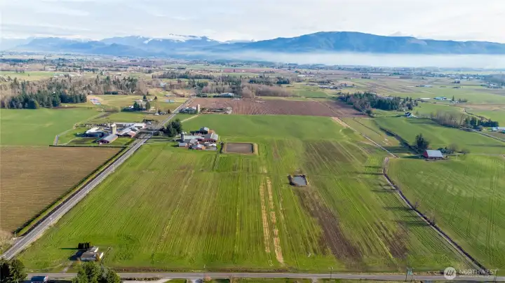 Full East view of  the farm and farm land. creek lines the Southern boundary. Established neighboring berry farms