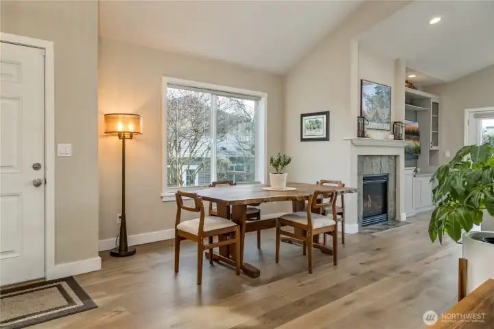 Enjoy meals by the fire in this light-filled dining space, perfectly situated between the kitchen and the cozy living area
