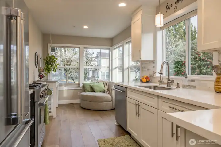 Bright kitchen was remodeled in 2021 with quartz counters, crisp white cabinets, stainless appliances
