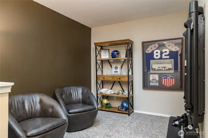 Versatile loft bonus room makes for a perfect home gym or media space. The wall-mounted Tonal smart home gym is negotiable!