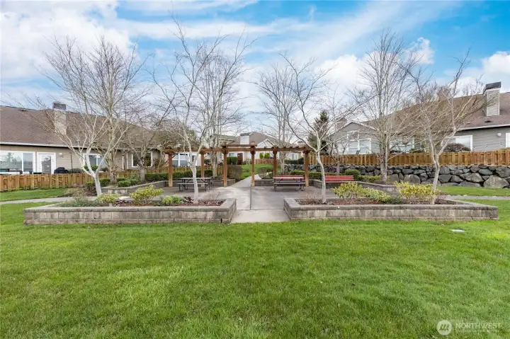 The serene community greenspace provides a beautiful backdrop for neighborhood gatherings or a quiet afternoon outdoors