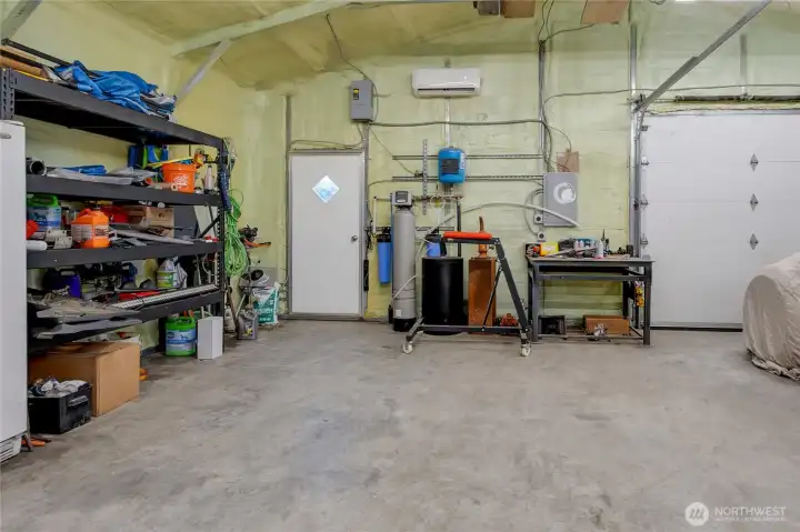 Detached shop showing water softner and well components