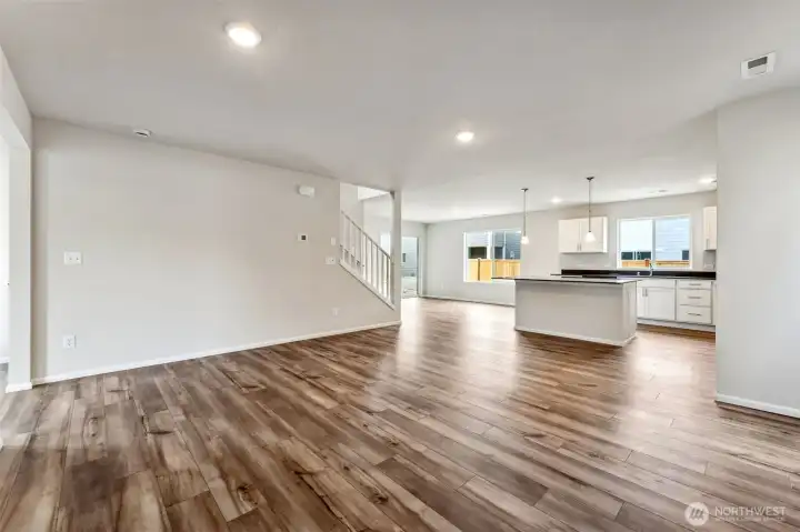 Open Concept living/Dining/Kitchen-Disclaimer- Photos are from a similar floor plan from another community, photos are for illustrative purposes only. Finishes, flooring, features, upgrades, countertops, paint, colors, and other features may vary.