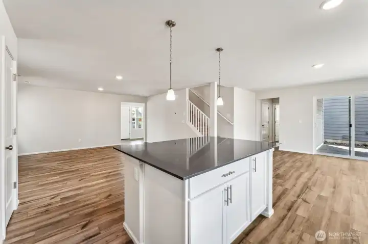 Open Concept living/Dining/Kitchen-Disclaimer- Photos are from a similar floor plan from another community, photos are for illustrative purposes only. Finishes, flooring, features, upgrades, countertops, paint, colors, and other features may vary.