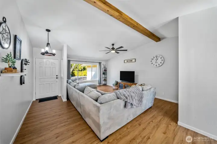 Updated stem to stern, there is hardly a finish in this home that has not been polished or replaced. Large, airy living room with a newer, stylish faux beam, LVP flooring and a newer picture window