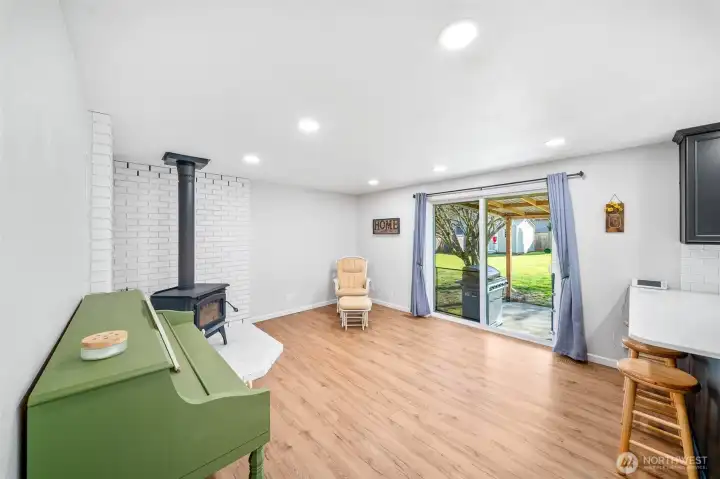 Spacious family room off of the kitchen offers a second living and gathering space, with a slider to the covered rear patio and yard