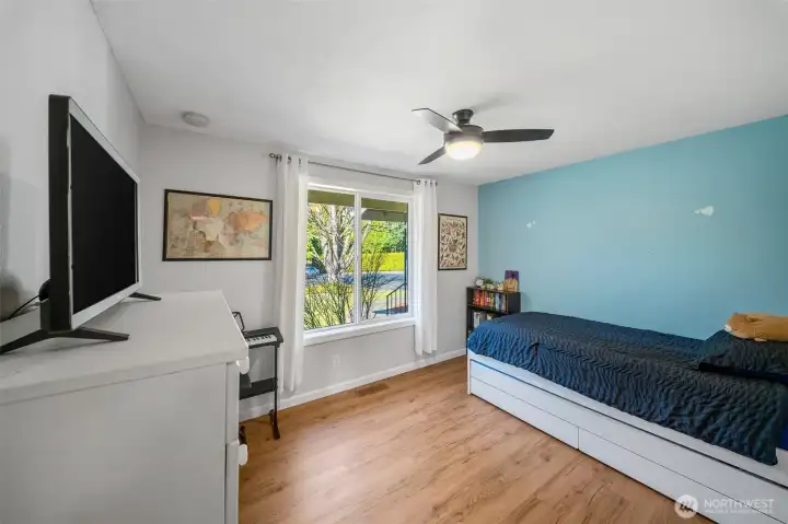 Bedroom #2 with ceiling fan, sunny window and LVP flooring for easy care