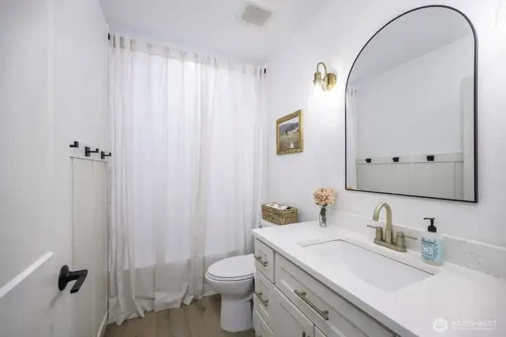 This full bath serves the two bedrooms on the opposite side of the home from the primary bedroom