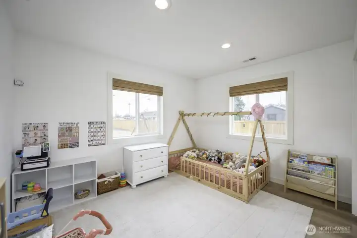 This bedroom is one of three total including the primary bedroom on the other side of the home