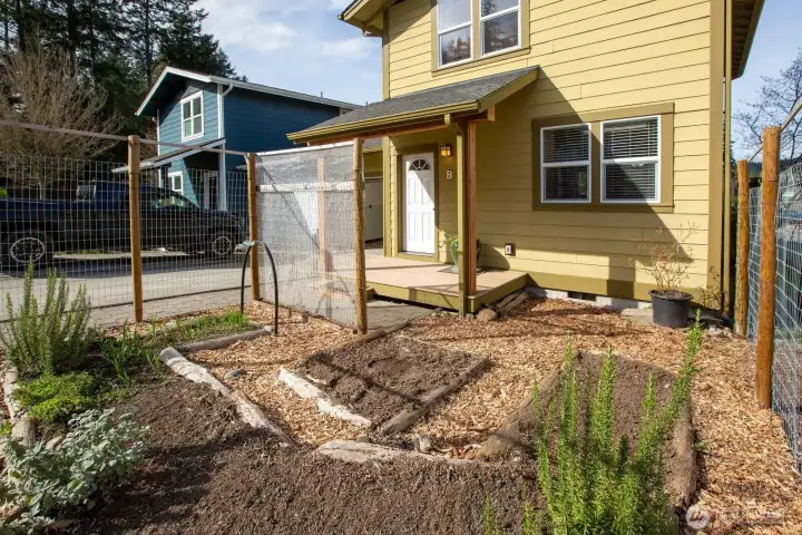 Front of townhouse faces south with a fenced-in deer proof garden area.