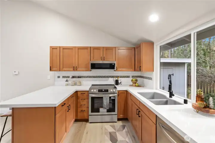 Spacious kitchen with new cabinet hardware and new faucet