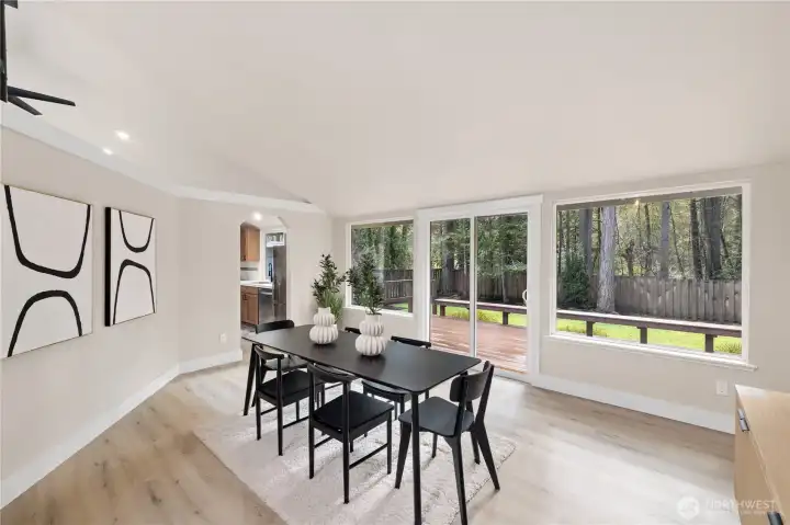 Expansive Dining Room with wall of windows and slider to large deck. Abundance of natural light