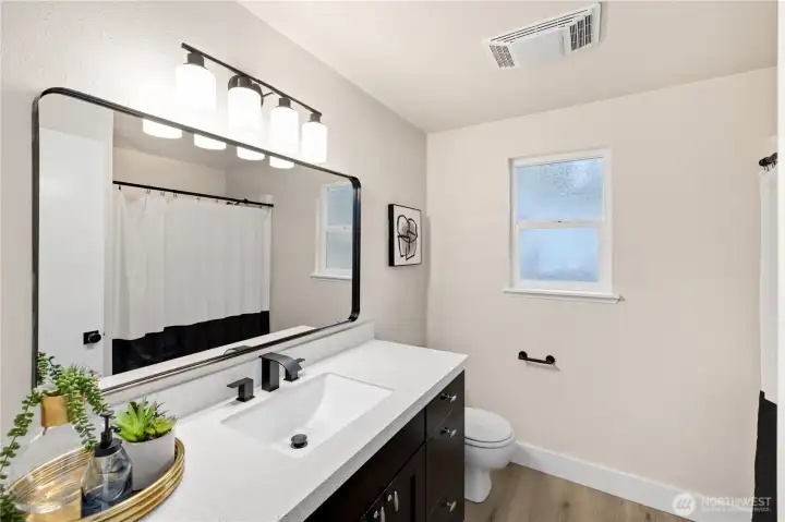 Primary attached bath, with new mirror, lighting, and faucets