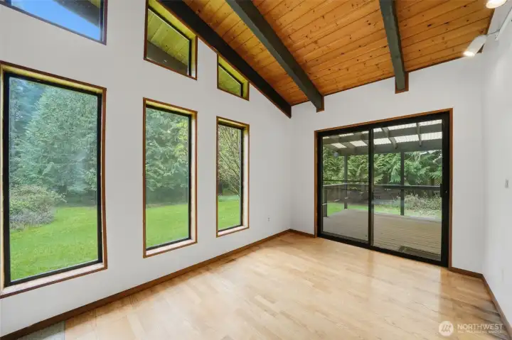 Expansive windows frame peaceful forest views, bringing the outdoors in.