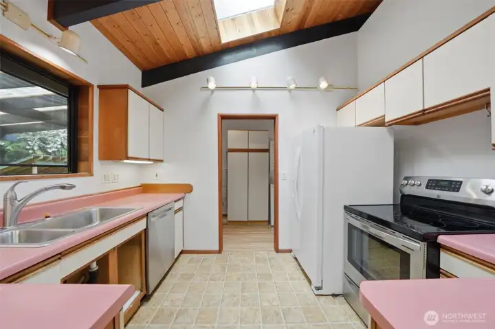 Functional kitchen features ample counter space and a skylight for natural brightness.