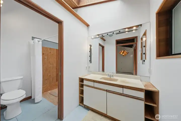 Second bathroom updated with modern fixtures and natural wood trim.