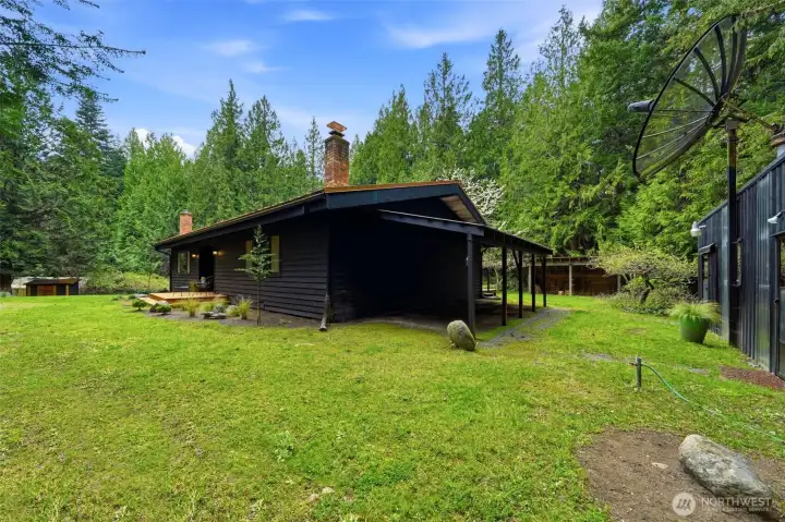 Rear view of the home showing the seamless integration with the natural landscape.