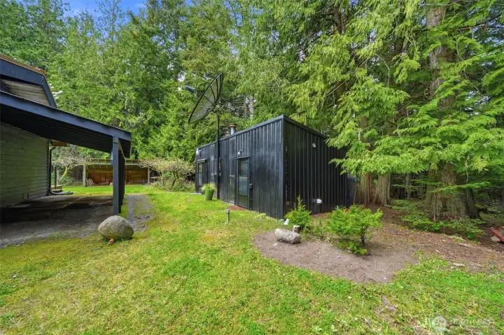 Expansive lawn and lush forest surround the property for ultimate privacy.