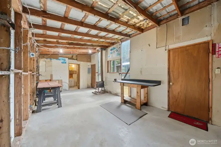 Shop interior includes workbenches and extensive storage capabilities.