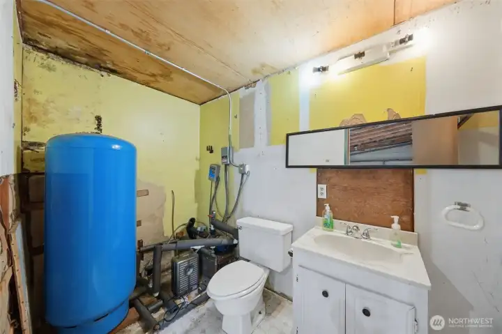 Utility area with high-efficiency water heater and additional storage.