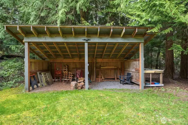Large covered storage bay ideal for firewood, equipment, or ATVs.