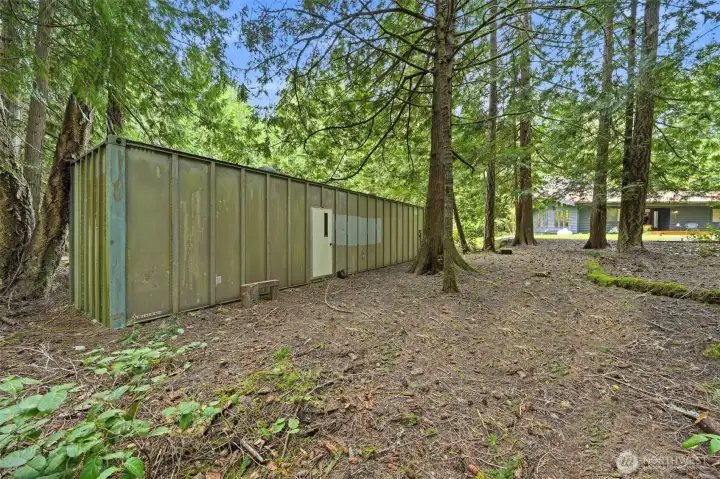 Secondary outbuilding provides even more covered storage or workspace options.