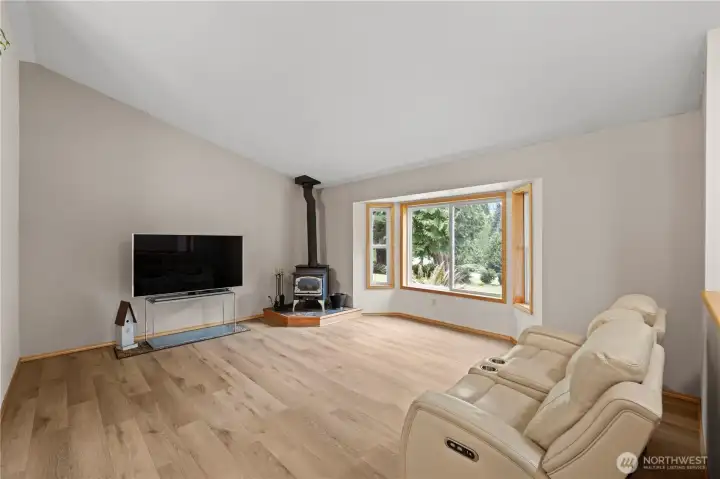 Original living room with bay window that floods the room with natural light.