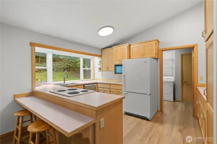 Kitchen features a breakfast bar and bay window with accent lighting, just ready for your custom style!