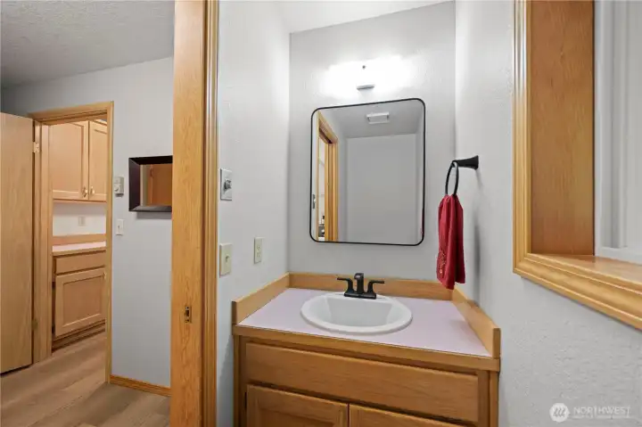 Half bath, next to the kitchen and laundry room.
