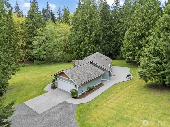 The home is tucked into the woods, but has flat or gently sloping usable acreage.