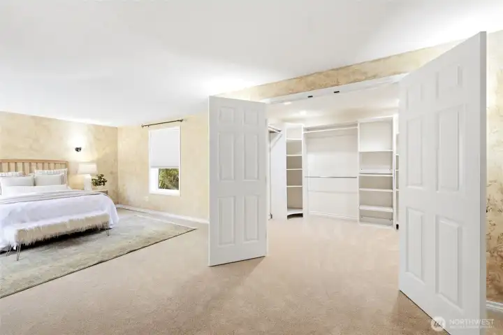 Walk-in closet with french doors in primary bedroom