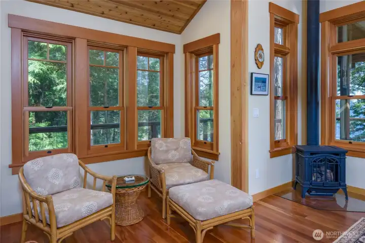 Propane stove keeps this sitting nook cozy, welcoming and warm. The home was designed with plenty of windows to maximize the view and the feeling of the forest surrounding you. Propane stove keeps this sitting nook cozy, welcoming and warm. The home was designed with plenty of windows to maximize the view and the feeling of the forest surrounding you.