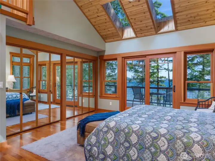 Main floor ensuite is filled with natural light with large windows that generously share this spectacular view of Dolphin Bay. French doors open up to the deck. Main floor ensuite is filled with natural light with large windows that generously share this spectacular view of Dolphin Bay. French doors open up to the deck.