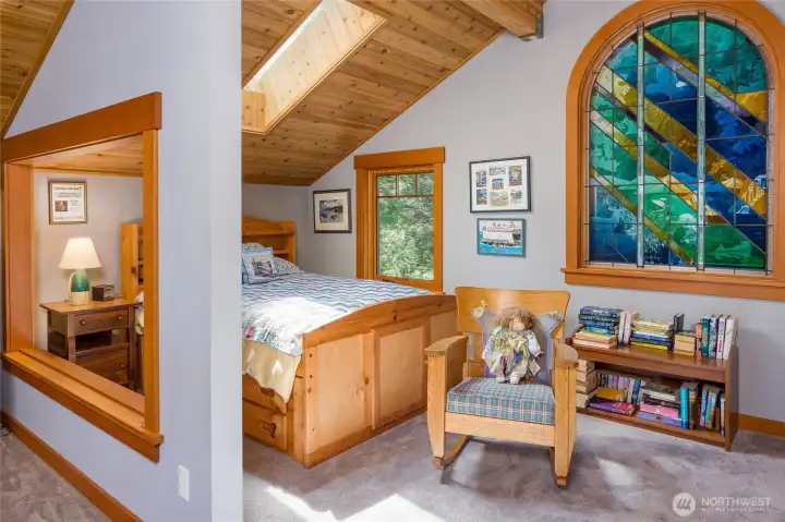 Upper ensuite, skylights brings in natural light, while stained glass window showers the room with color. Upper ensuite, skylights brings in natural light, while stained glass window showers the room with color.