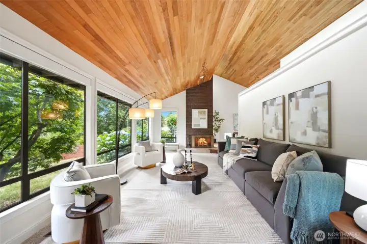 Front living room with soaring wood-clad ceilings & lush green views
