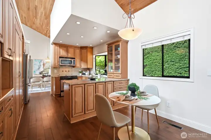 Light-filled eat-in kitchen with beautiful backyard views