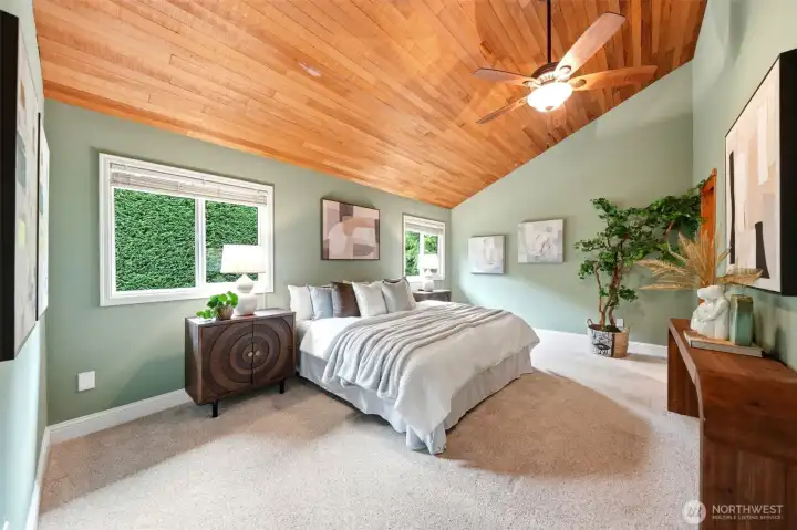Primary retreat featuring dramatic ceilings & tranquil views